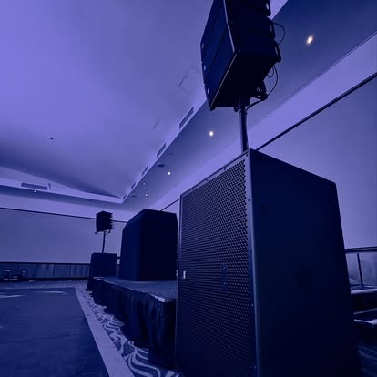 Large speaker stacks beside a stage