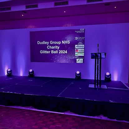 Purple-lit stage with lectern