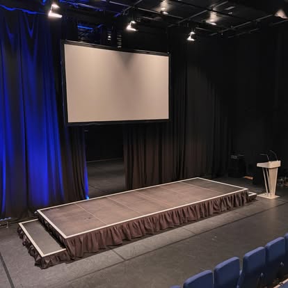 Theatre style stage with screen and lectern