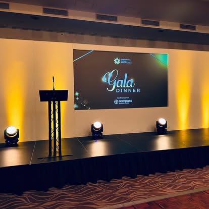 Gala dinner stage with screen and uplighting