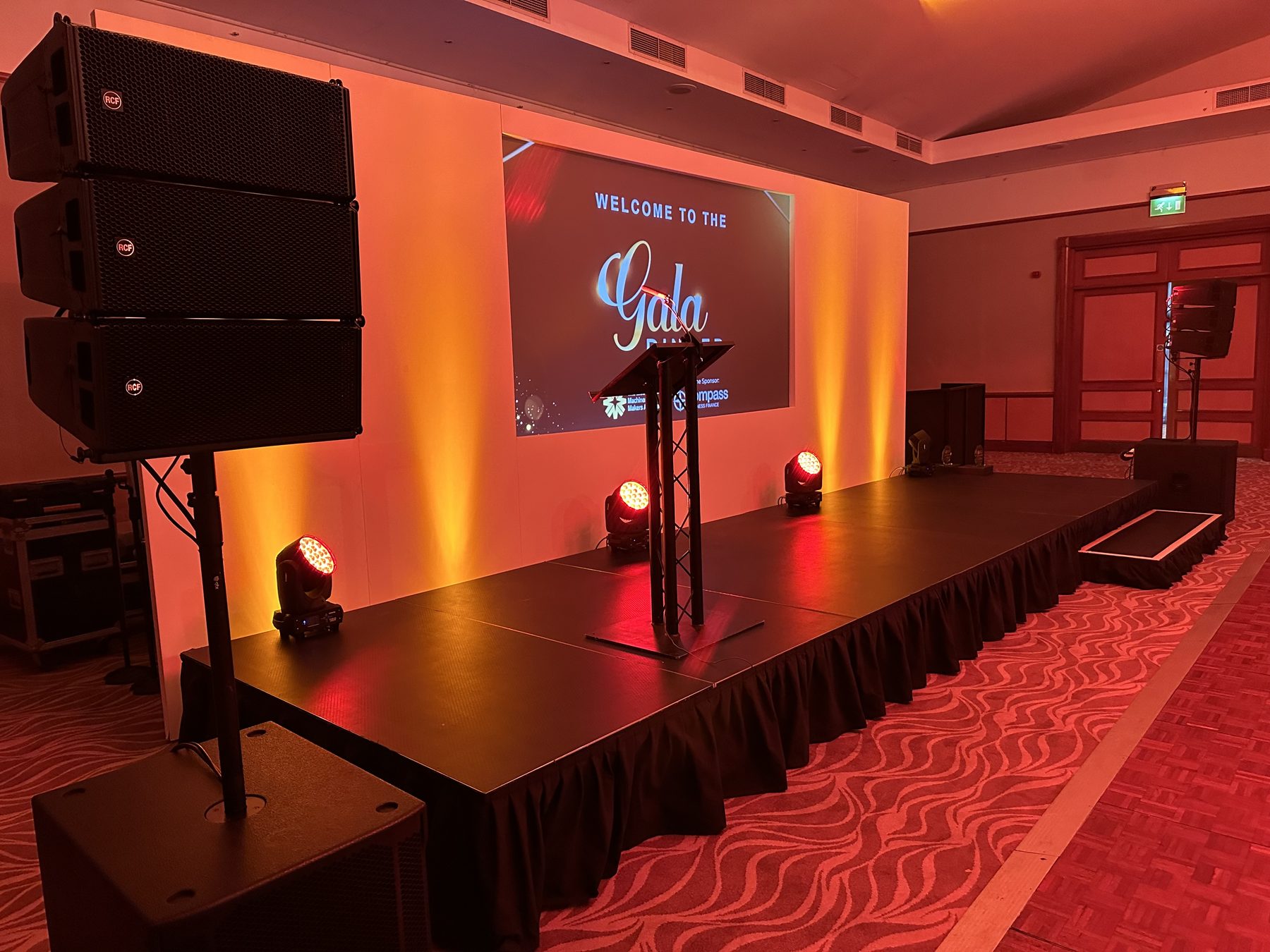 Birmingham presentation stage with lectern, screen, lighting and PA speakers