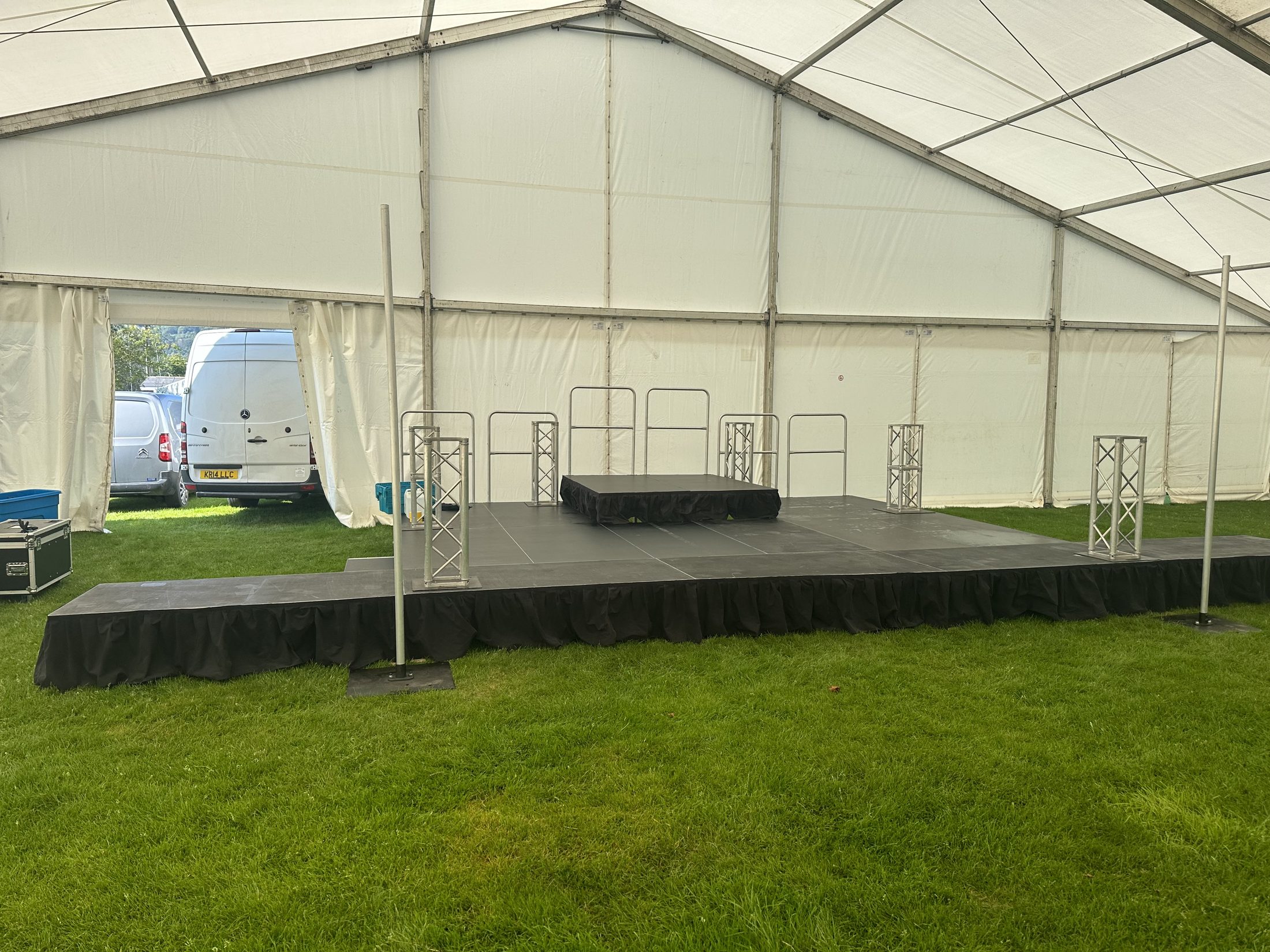 Large stage inside a marquee on grass