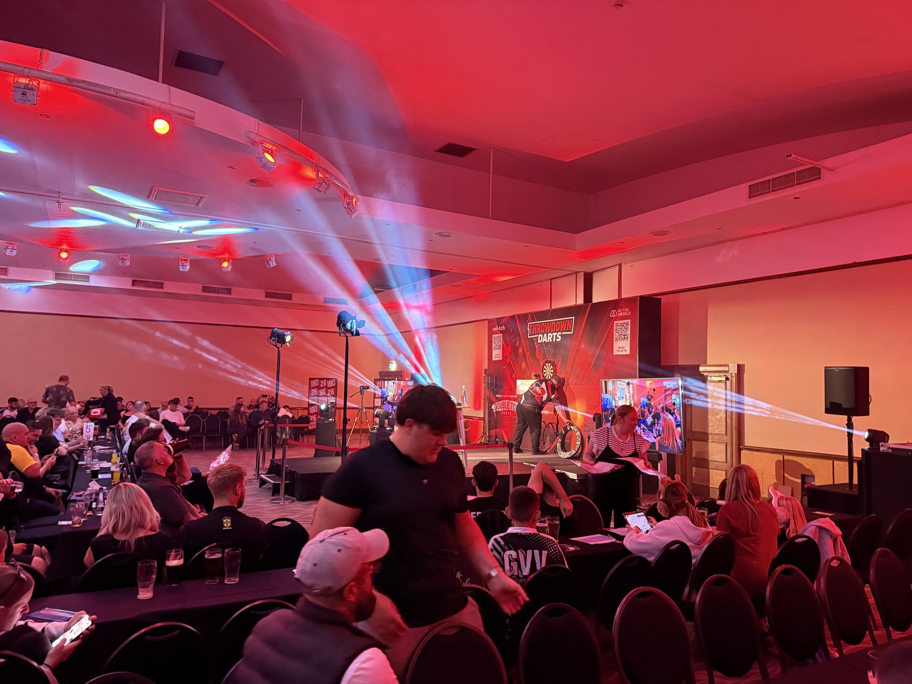 Live Throwdown Darts event with audience, screens and stage lighting