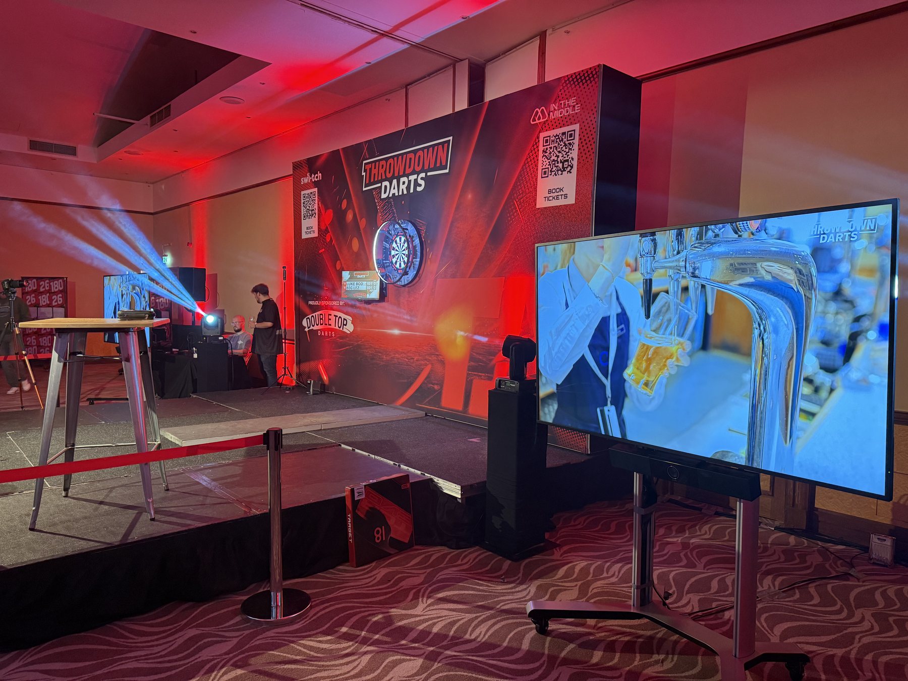 Throwdown Darts stage with large video screen and event lighting