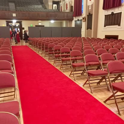 Red carpet walkway through audience seating