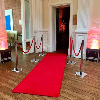 Red carpet entrance walkway with rope barriers