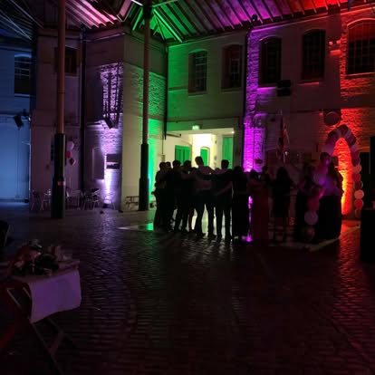 Multi-colour uplighting in a courtyard