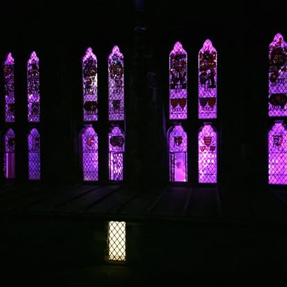 Lit stained glass windows in purple