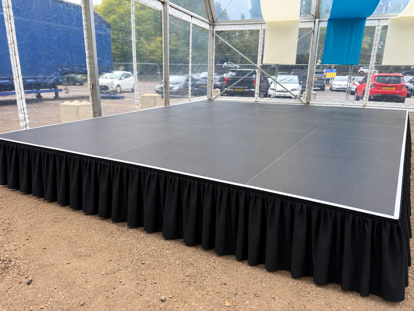 Raised black stage setup with black drape surround for Reading Fest