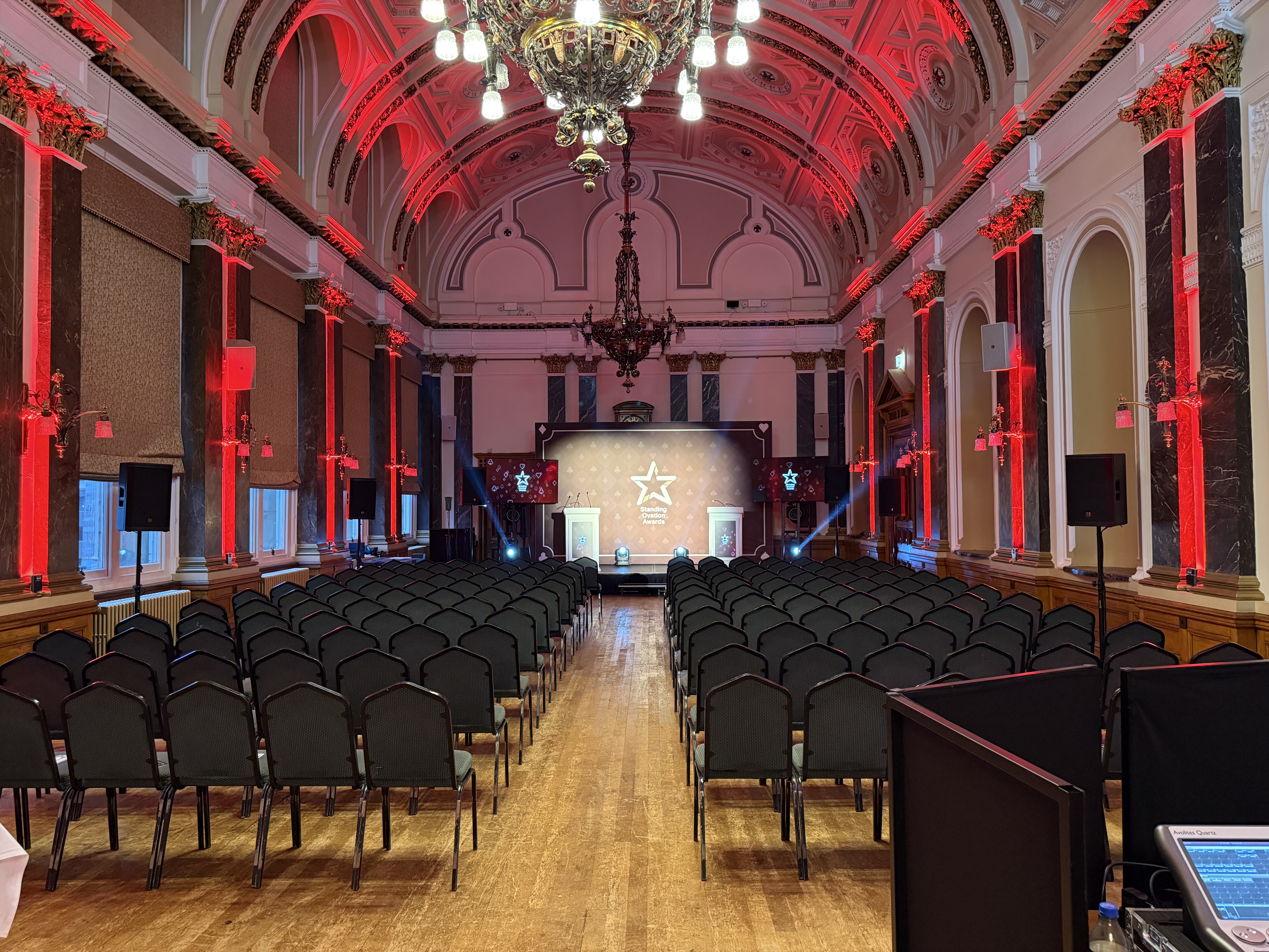 Standing Ovation Awards room setup at Birmingham Town Hall with red lighting and stage wash
