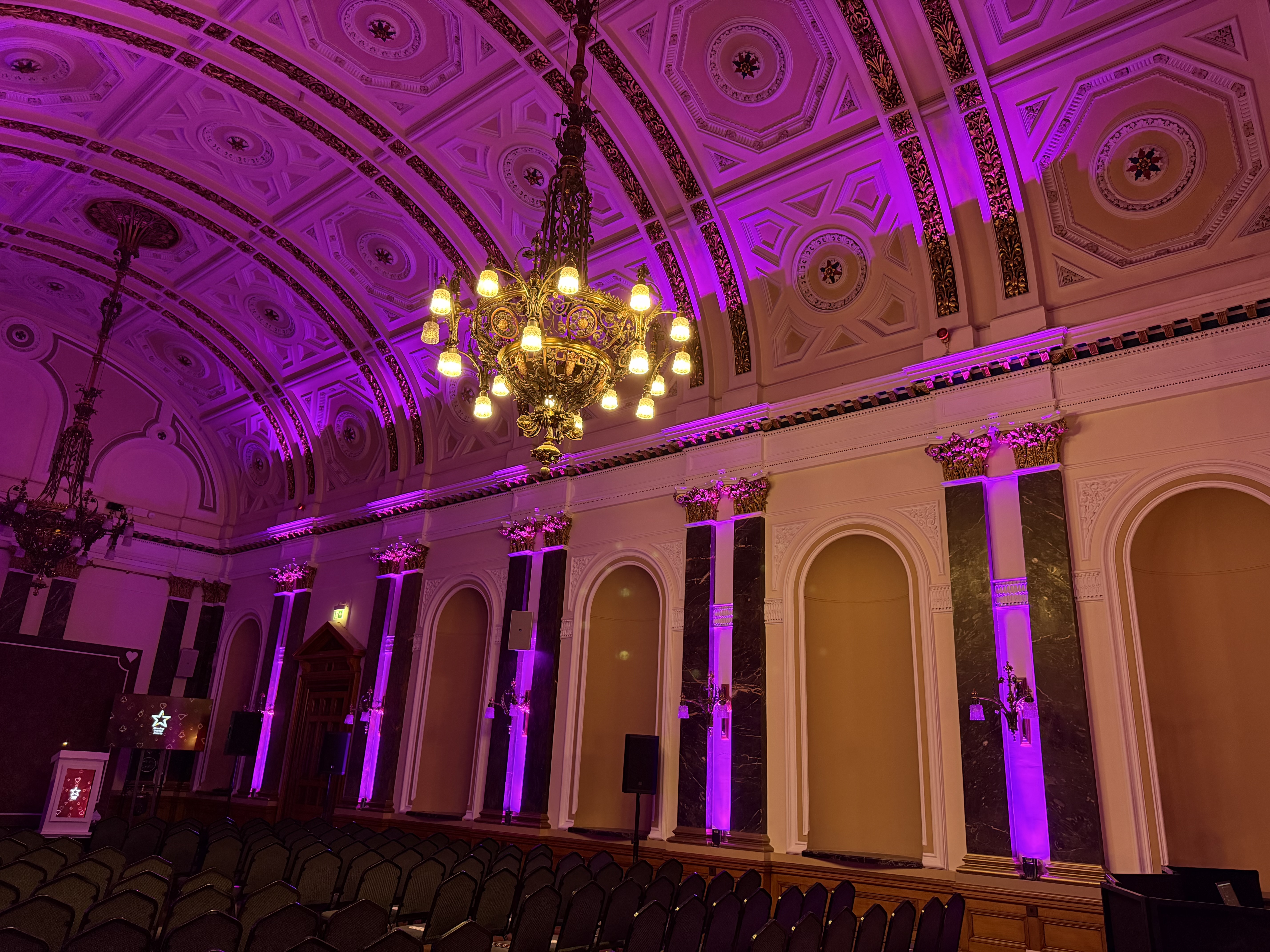 Pink and purple architectural lighting wash inside Birmingham Town Hall